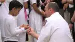 HSS volunteer ties rakhi bracelet on firefighter