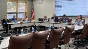 Wide shot of board members seated at D203 board meeting