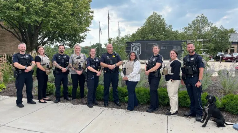 Members of the Naperville Mobile Crisis Intervention Team pose in front of the police department for a photo