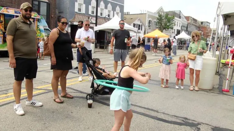 A girl hula hoops at the Naperville Neighborly Day block party.