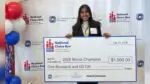 Astha Savalia of Naperville holds giant check from National Civics Bee competition