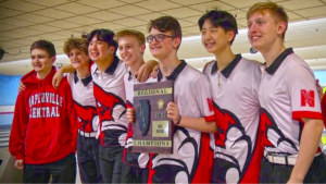 The 2023 Naperville Central boys bowling team poses with the DVC champions plaque.