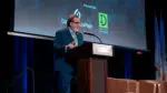 A man gives a presentation at a podium at College of DuPage for Innovation DuPage.