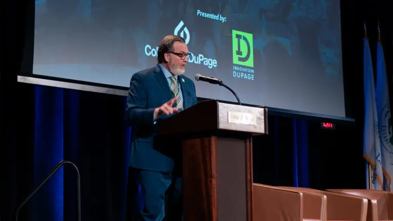 A man gives a presentation at a podium at College of DuPage for Innovation DuPage.