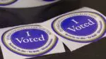Close up of 2 I voted stickers from DuPage County