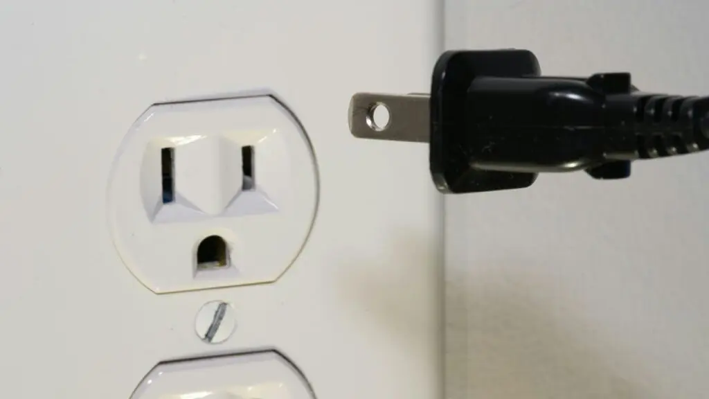 Close up of power cord by outlet