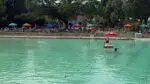 Wide shot of Centennial Beach with lifeguard stationed in water