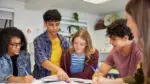 A group of students work together on an assignment