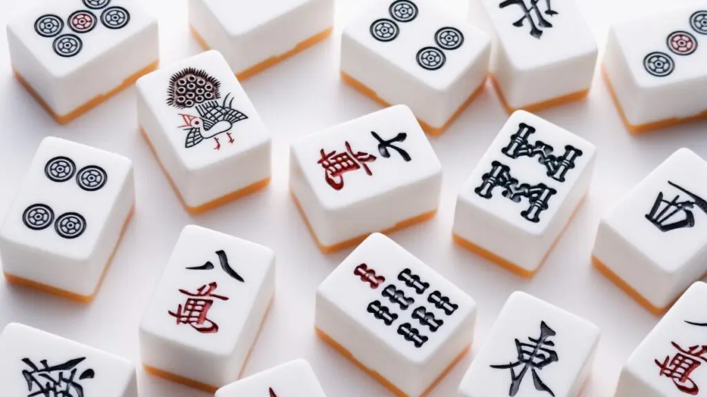 Mahjong tiles sit on a table