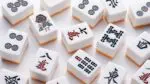 Mahjong tiles sit on a table