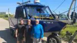 Bruce's Legacy team in front of recovery boat
