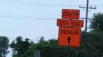An orange detour sign points to road closures along Book Road in Naperville