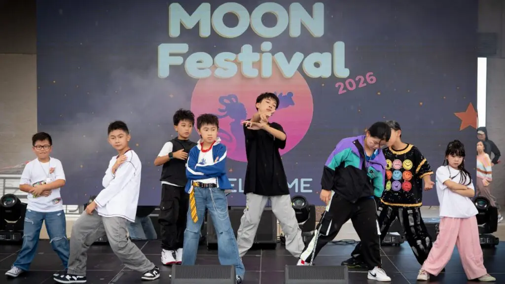 A performance group dances on stage at the Moon Festival in Aurora