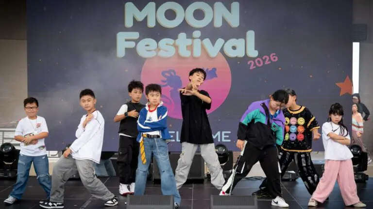 A performance group dances on stage at the Moon Festival in Aurora