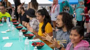 Competitors in the Moon Festival's ramen-eating contest wait to dig in to their bowls.