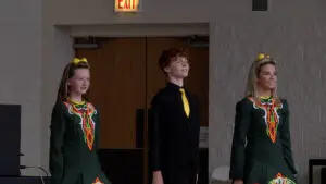 A trio of Irish dancers performs on stage