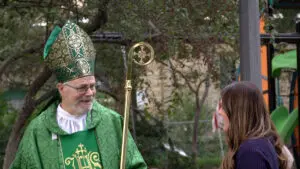 A man dressed as St. Patrick speaks with another person