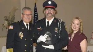 Andy Winckler with fire chief and CAPS chairperson at ceremony