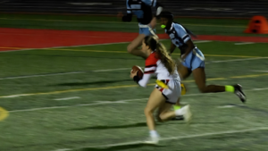 Benet's Ava Mersinger runs with the football.