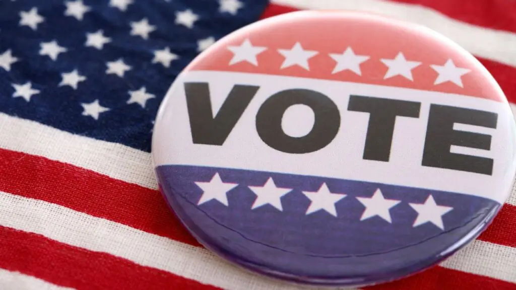 Close up of Vote pin on American flag