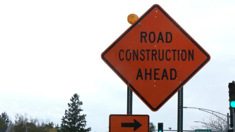 Orange road construction ahead sign
