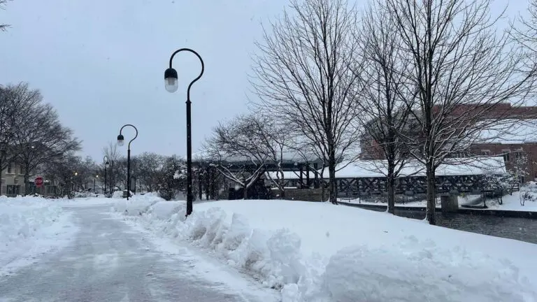 Snow covers a bridge on the Naperville Riverwalk in the winter