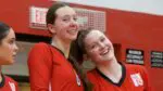 Naperville Central girls volleyball players smile before taking the court