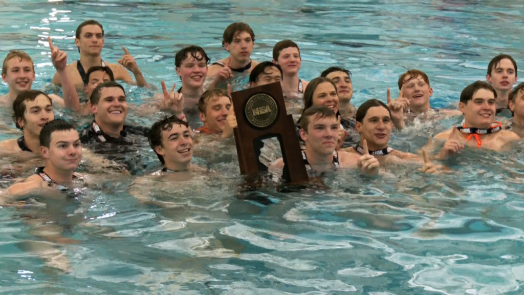 Naperville North boys water polo catches a team photo with the state trophy.
