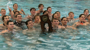 Naperville North boys water polo catches a team photo with the state trophy.