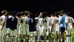 Naperville North boys soccer huddles during postgame.