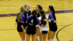 Downers Grove North girls volleyball huddles in win over Metea.