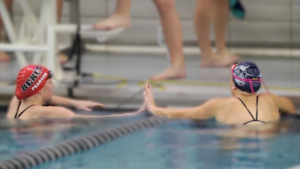 Claire Simon and Coco Pearson show sportsmanship in the pool.
