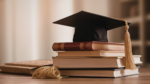 graduation cap on a stack of school books
