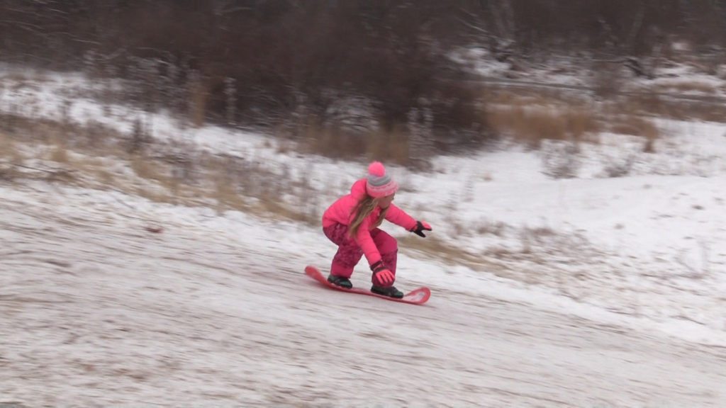 Kid ride down sledding hill in Naperville in 2018.