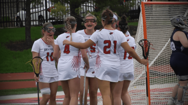 North Central women's lacrosse players celebrate a goal