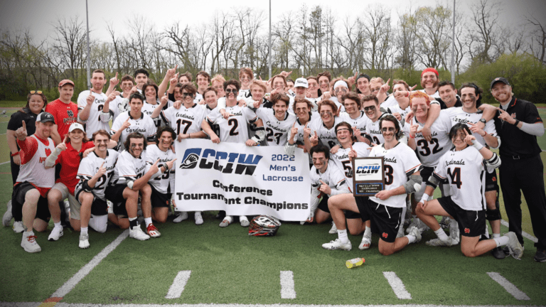 North Central Men's Lacrosse poses with the CCIW championship banner