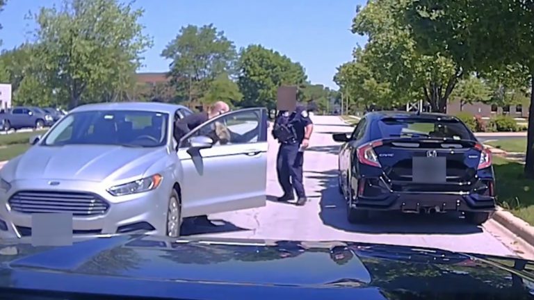 dashcam police car image of man charging officer with hatchet
