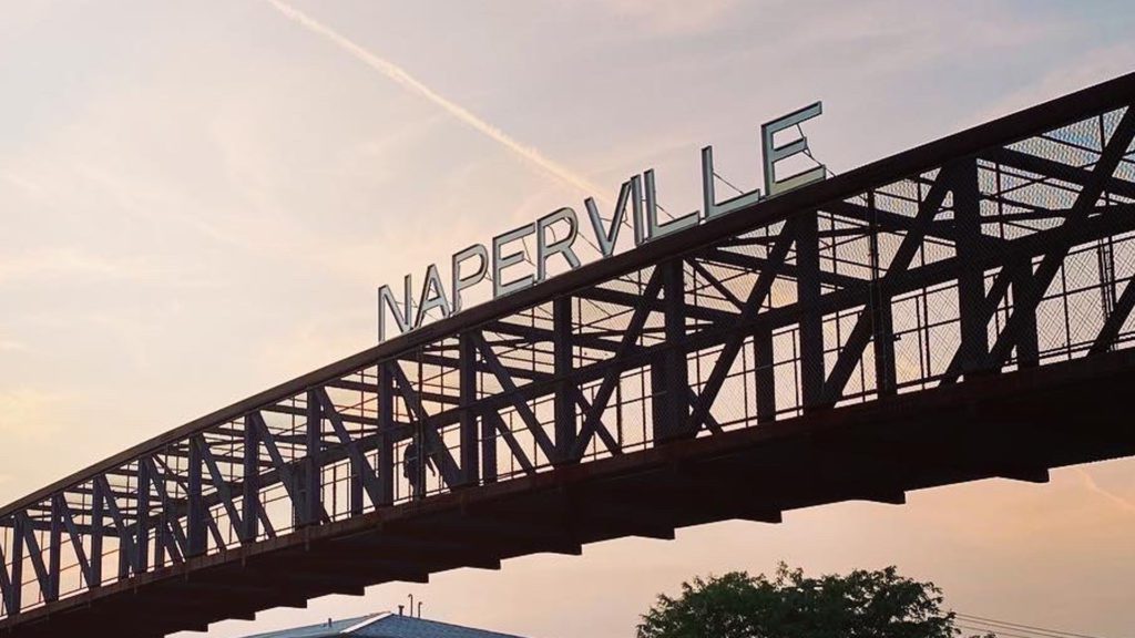 Naperville sign on pedestrian bridge over Rt.59 at sunset