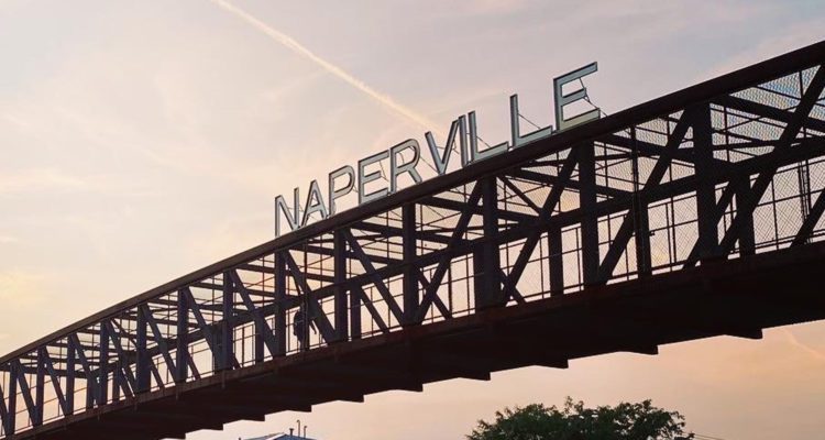 Naperville sign on pedestrian bridge over Rt.59 at sunset