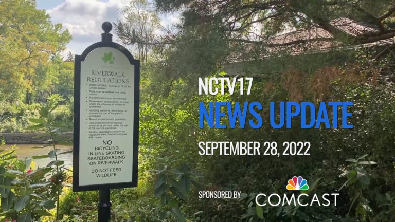 News Update slate for Sept 28 with beauty shot of Riverwalk sign, trees in background, school districts within stories of day