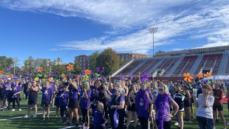 People holding flowers during promise garden ceremony