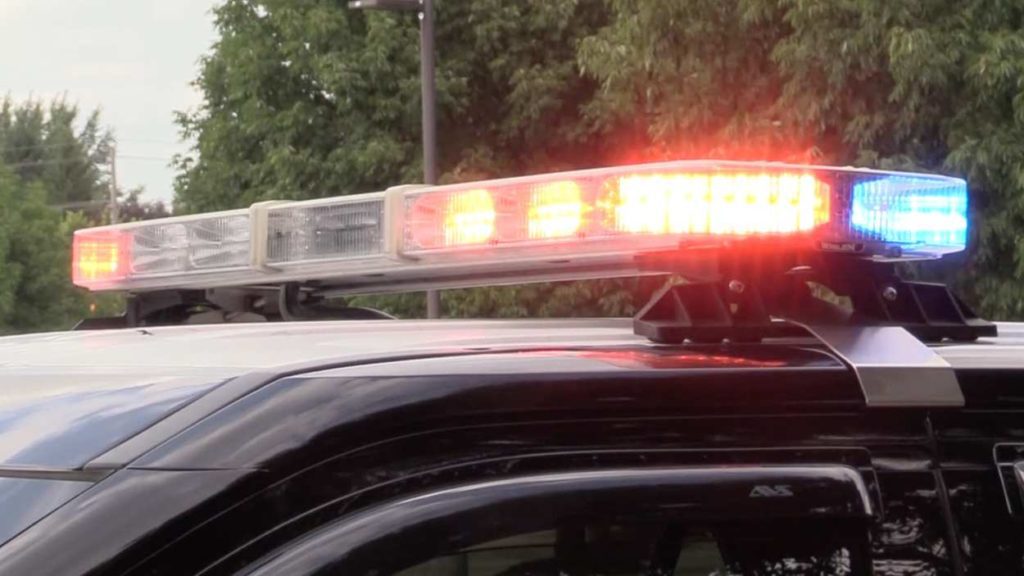 file image of police car flashing red and blue lights