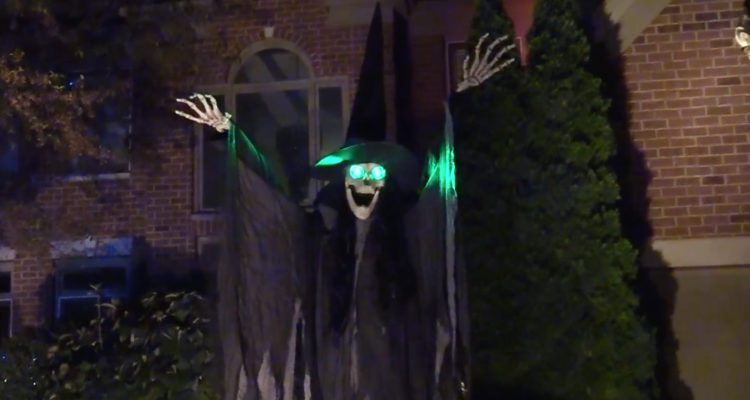 Spooky Witch in Halloween display in front of home