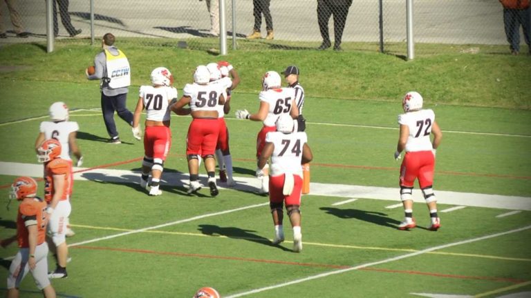 North Central players hug after a touchdown