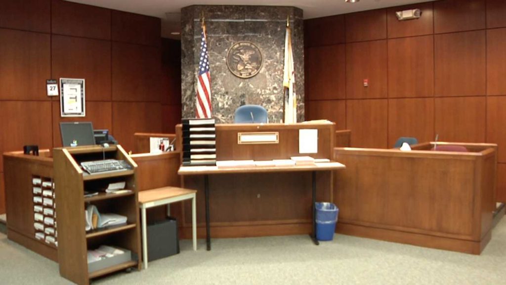 file image of empty courtroom, judge's bench