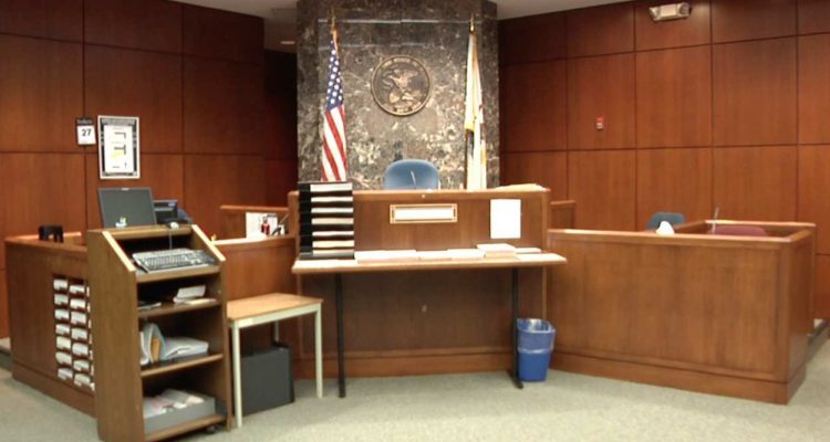 file image of empty courtroom, judge's bench
