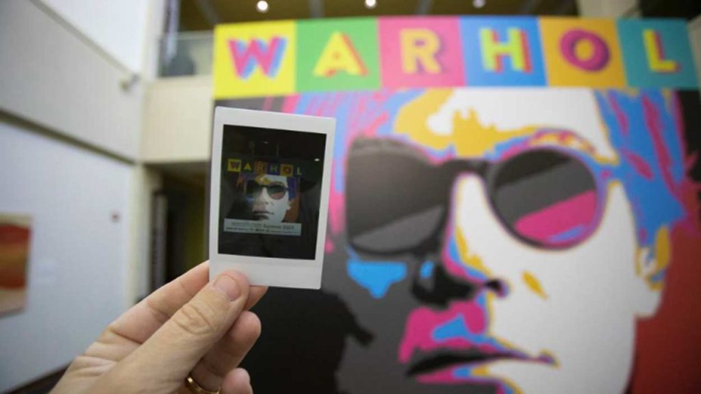 Warhol photograph in front of mural