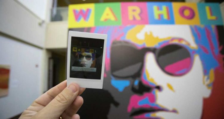 Warhol photograph in front of mural