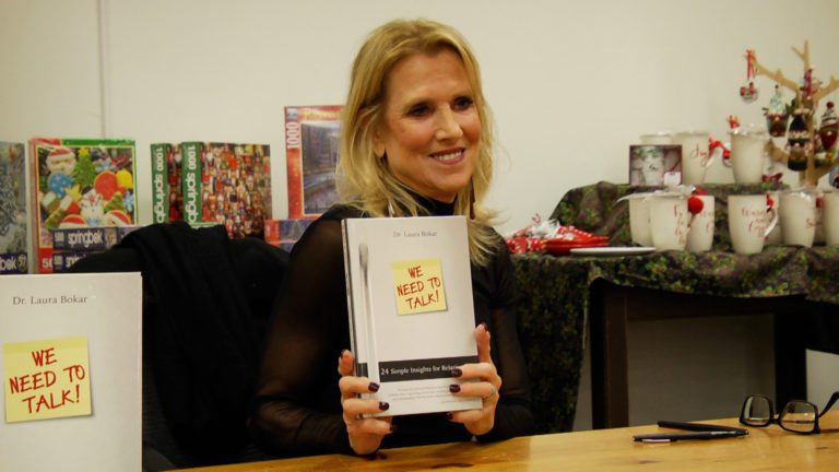 Dr. Laura Bokar Holds her book at Anderson's Bookshop