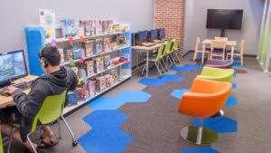 Kid playing a game in the kids section of Naper Boulevard Library